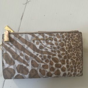 Michael kors medium wallet. Has a place to store your phone as well. Like new